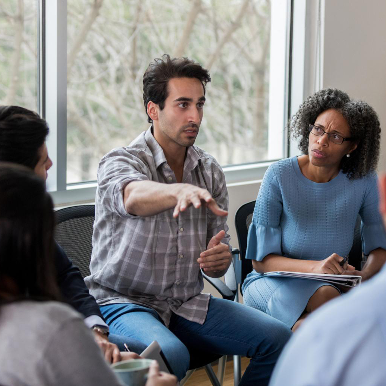 group of people sitting and discussing something